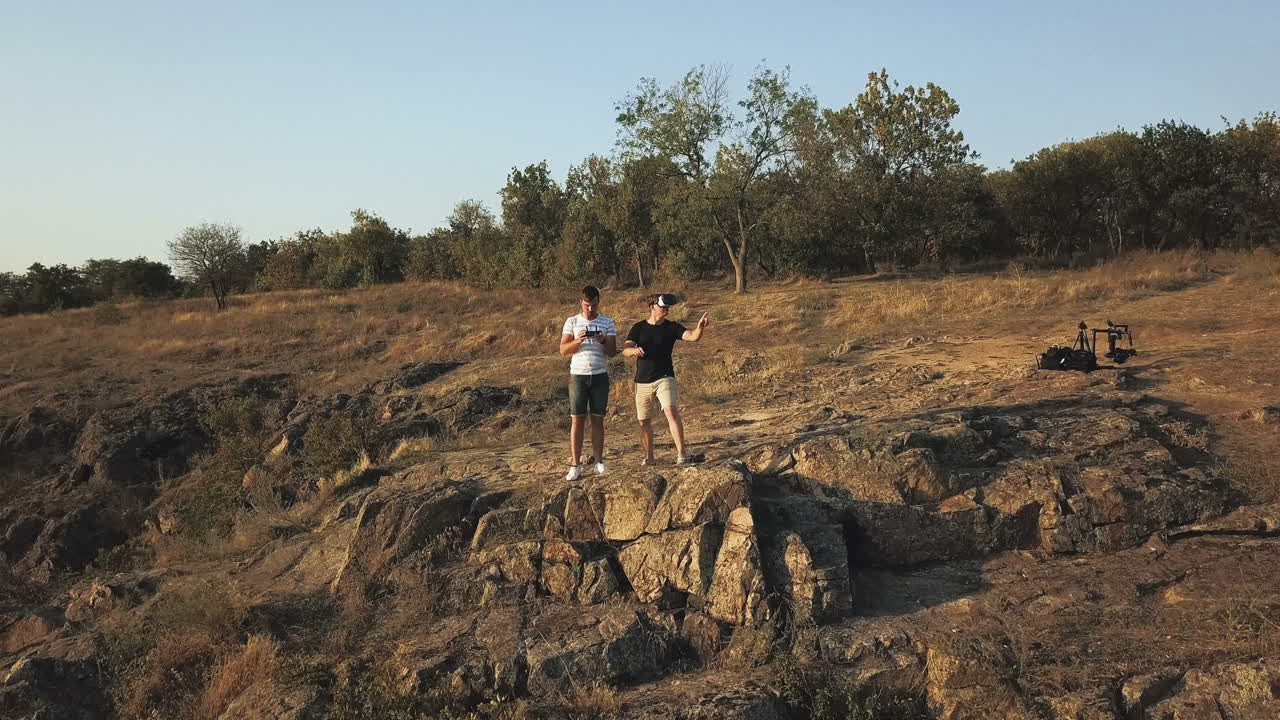 Drone Operators on Rocky Outcrop