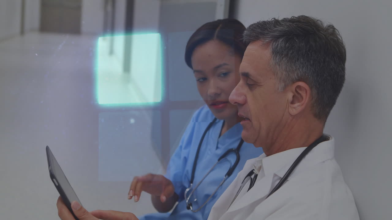 Discussing patient data, healthcare professionals using digital interface in hospital