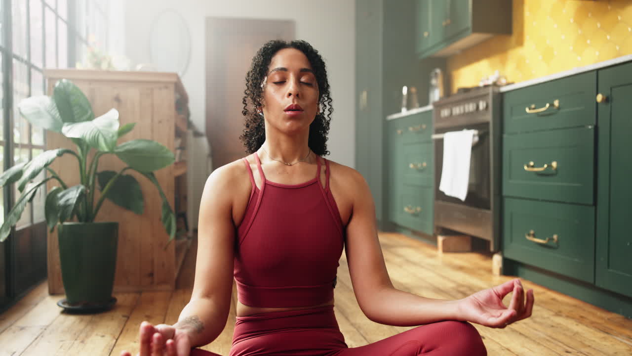 Peaceful Woman Meditating in Lotus Pose at Home