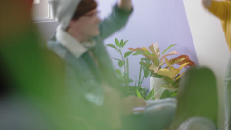 young-group-of-students-celebrating-redhead-team-leader-woman-dancing-funny-enjoying-victory-dance-friends-celebrate-successful-teamwork-in-happy-colorful-office-presentation