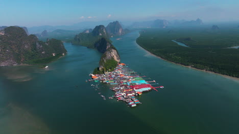 limestone formations and floating village in koh panyee in phang nga bay, thailand. aerial drone shot