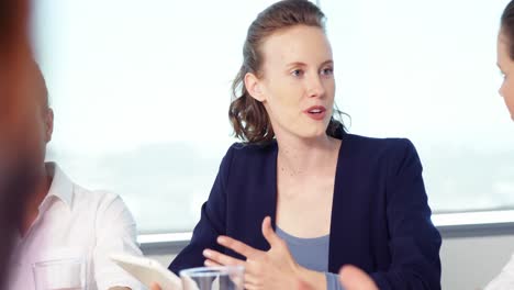 business executives interacting with each other in conference room