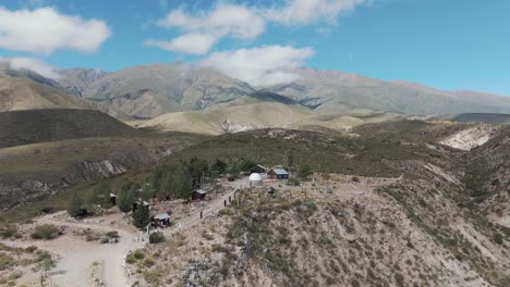 Aerial-above-majestic-mountain-landscape-in-Amaicha-del-Valle,-Argentina-with-astronomical-tower