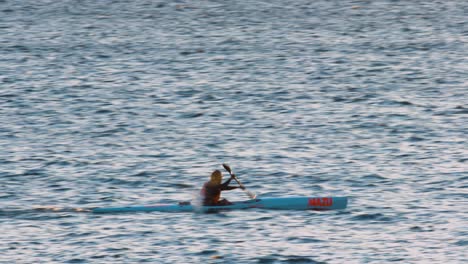 man rowing in canoe in the sea in cascais