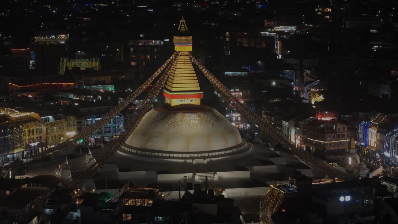 Nighttime view of Boudhanath Stupa in Kathmandu, beautifully illuminated with warm lights, showcasing its spiritual ambiance, stunning architecture, and serene Buddhist atmosphere