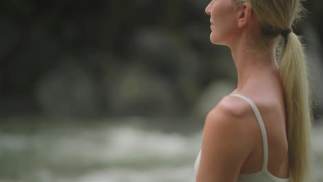 calm young woman in easy pose with eyes closed, relaxing body and mind