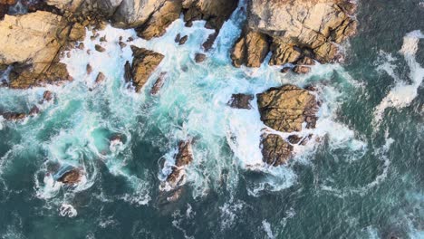 zenith view above cliff and waves at sunrise in oaxaca's shore, mexico