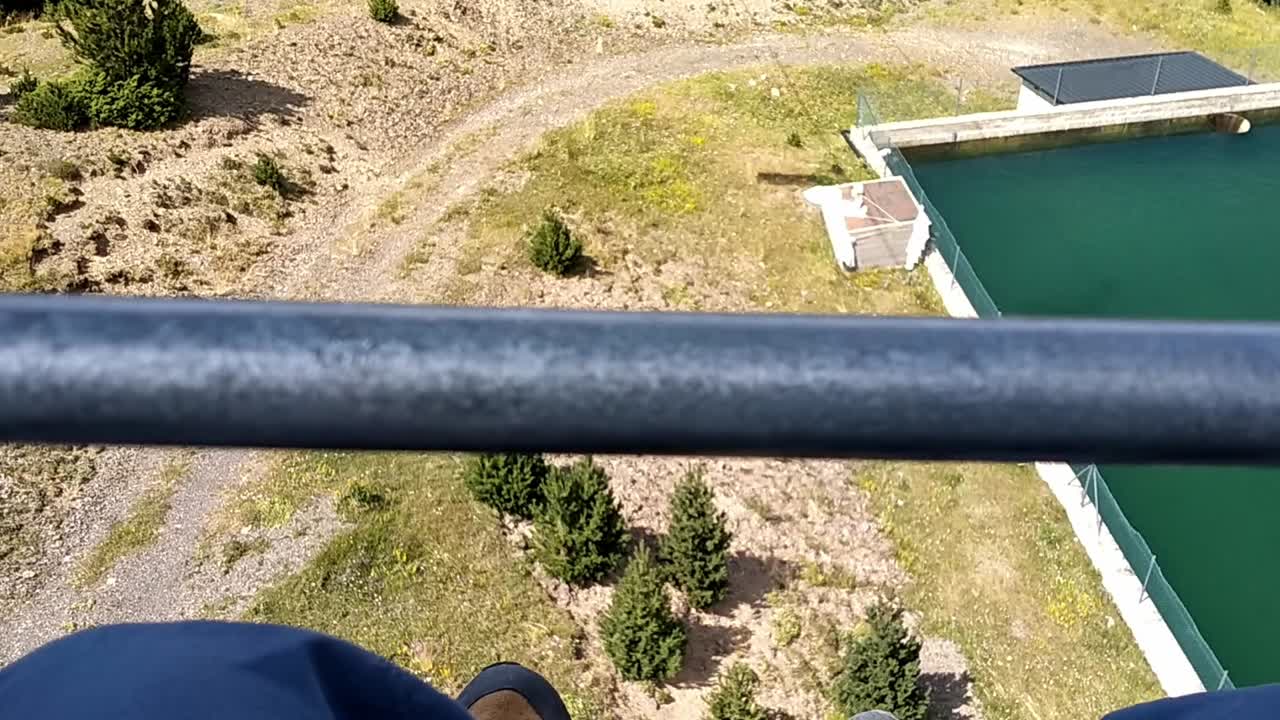 Pyrenees view from chairlift overlooking a tranquil mountain pool