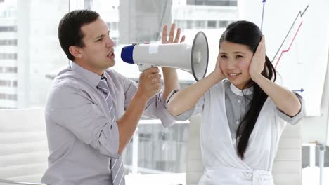 Caucasian-businessman-yelling-through-a-megaphone