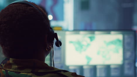 woman military personnel tracking enemy vessels on the coast line territory