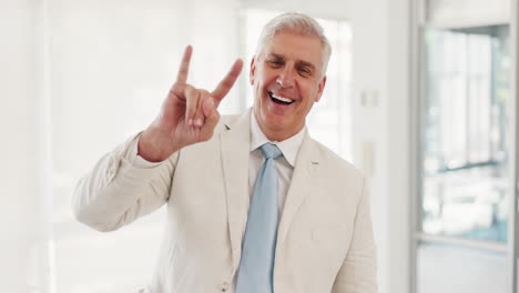 Senior-businessman,-rock-hand-sign