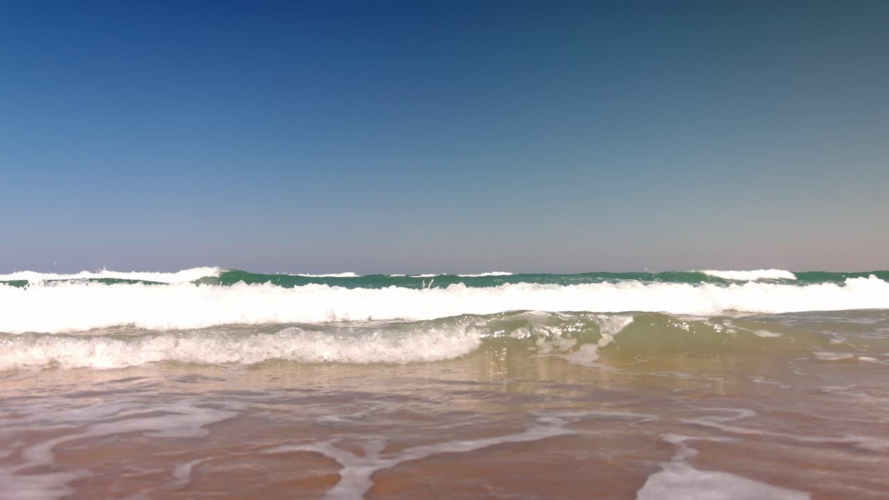 Waves in the Atlantic Ocean in Daytona Beach, Florida with low shot in slow motion.