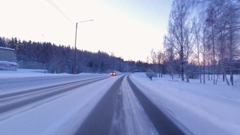 pov shot driving along a snowy road with clean tracks made