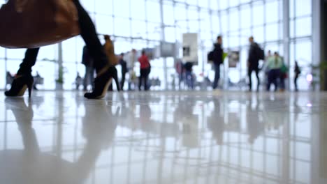 people walk inside a bright, modern building