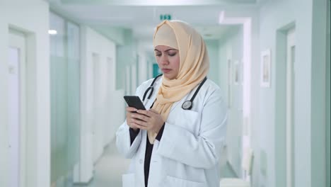 angry muslim doctor messaging someone on phone