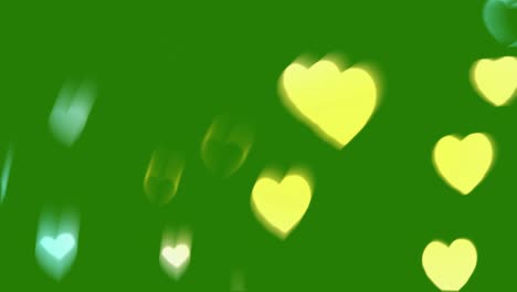 abstract blurred hearts on green background