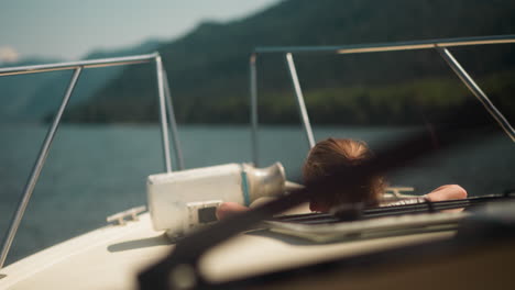 active little girl with back brace goes down to motorboat cabin sailing tranquil sea. child travels by comfortable yacht at oceanside on summer holiday