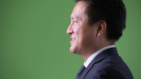 녹색 배경에 성숙한 일본 사업가