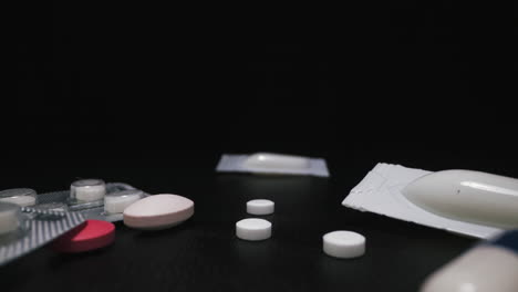 motion from suppository over scattered drugs on dark surface