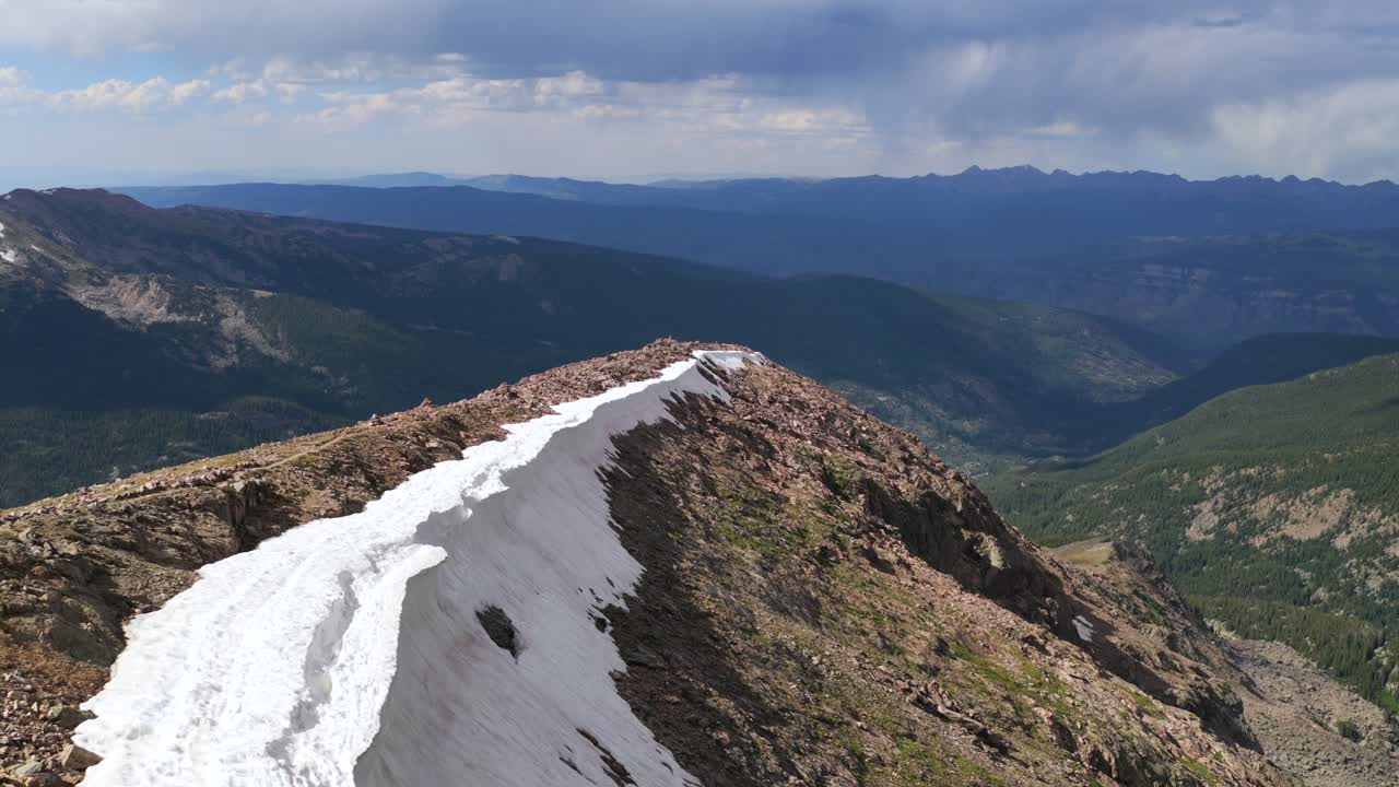 North Ridge trail 14er summit Mount of the Holy Cross peak Sawatch Range Colorado aerial drone Rocky Mountains spring summer snow field cornice chute blue sky Elk Mountains landscape view forward