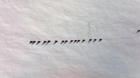 Aerial-view-of-people-on-snowmobiles-on-the-frozen-ground-of-Myrdalsjokull-glacier-in-Iceland