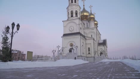 orthodox church with golden domes in winter