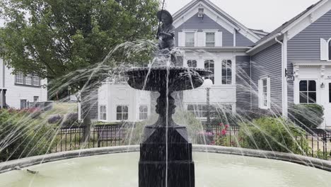 black fountain with a boy fishing in a rural town