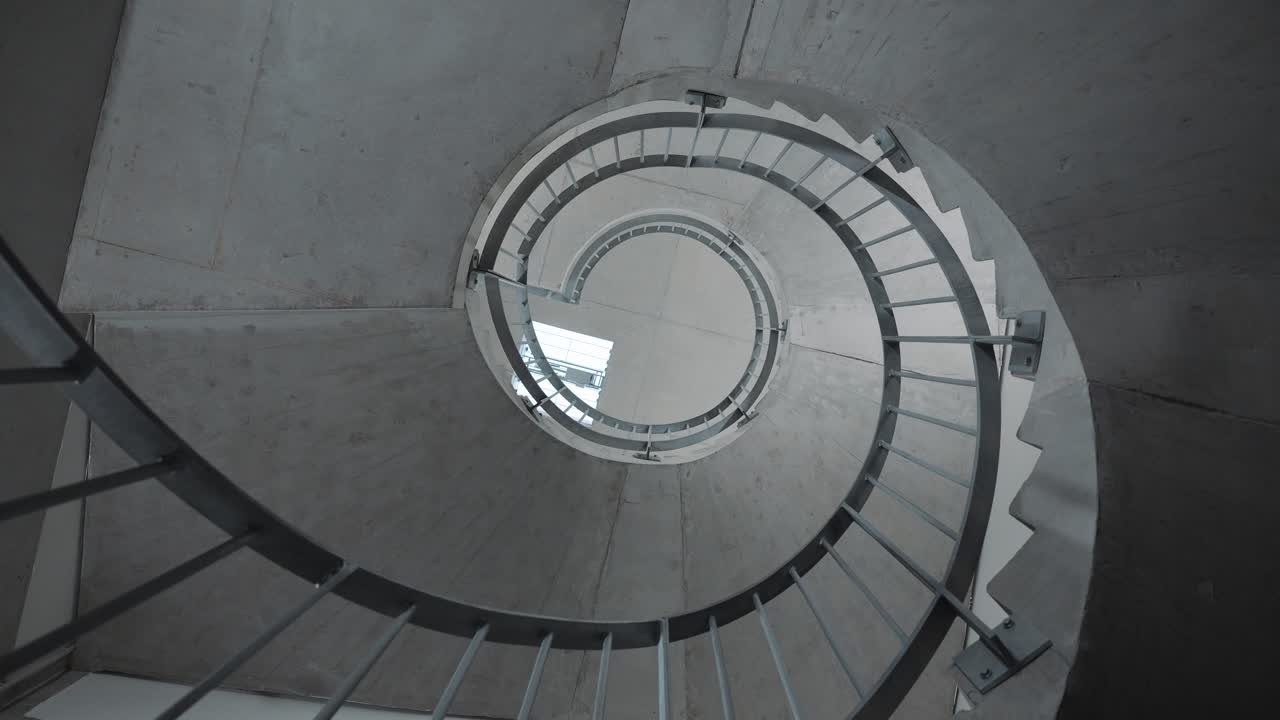 spinning shot of a beautiful stone spiral staircase within a hotel