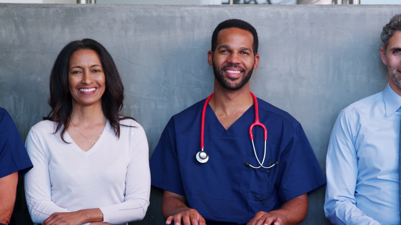 Five smiling  healthcare professionals, male and female
