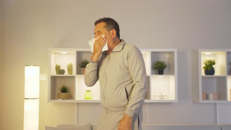 man covering his mouth and nose while coughing.