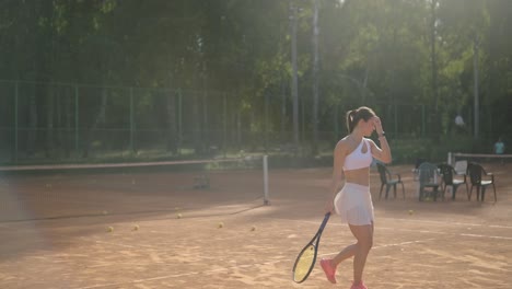 beautiful tennis girl practicing serve on outdoor court