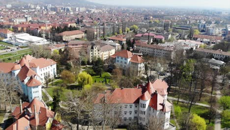 aerial drone shot paning over above universitatea oradea campus library with students