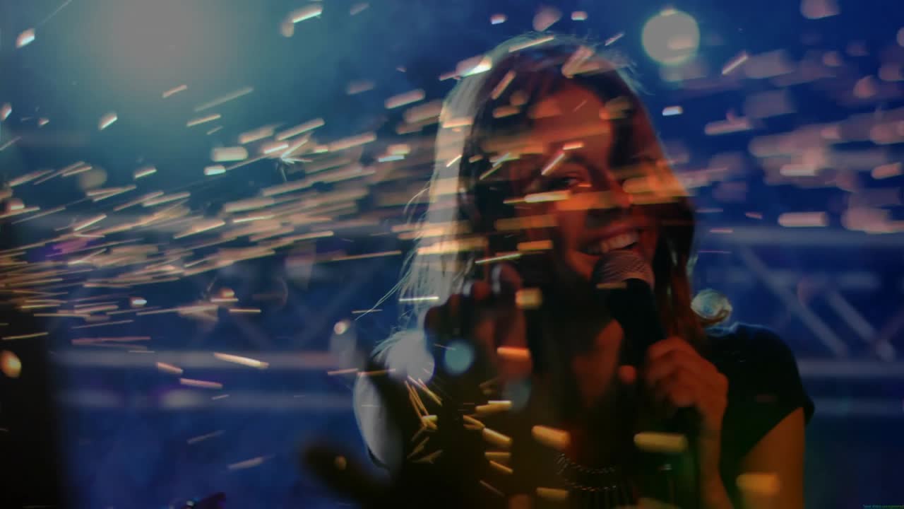 Pyrotechnic device emitting golden sparks initiating singer adjusting mic and singing in music show