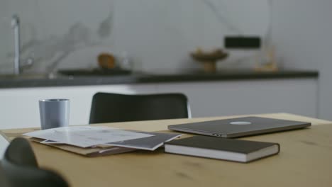 modern kitchen workspace with laptop and notebook