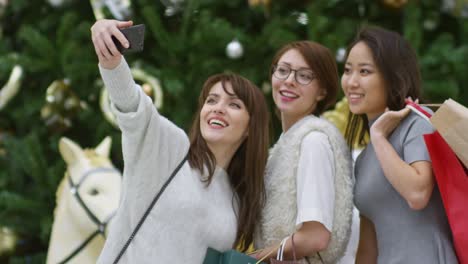 friends posing for selfie on holiday shopping