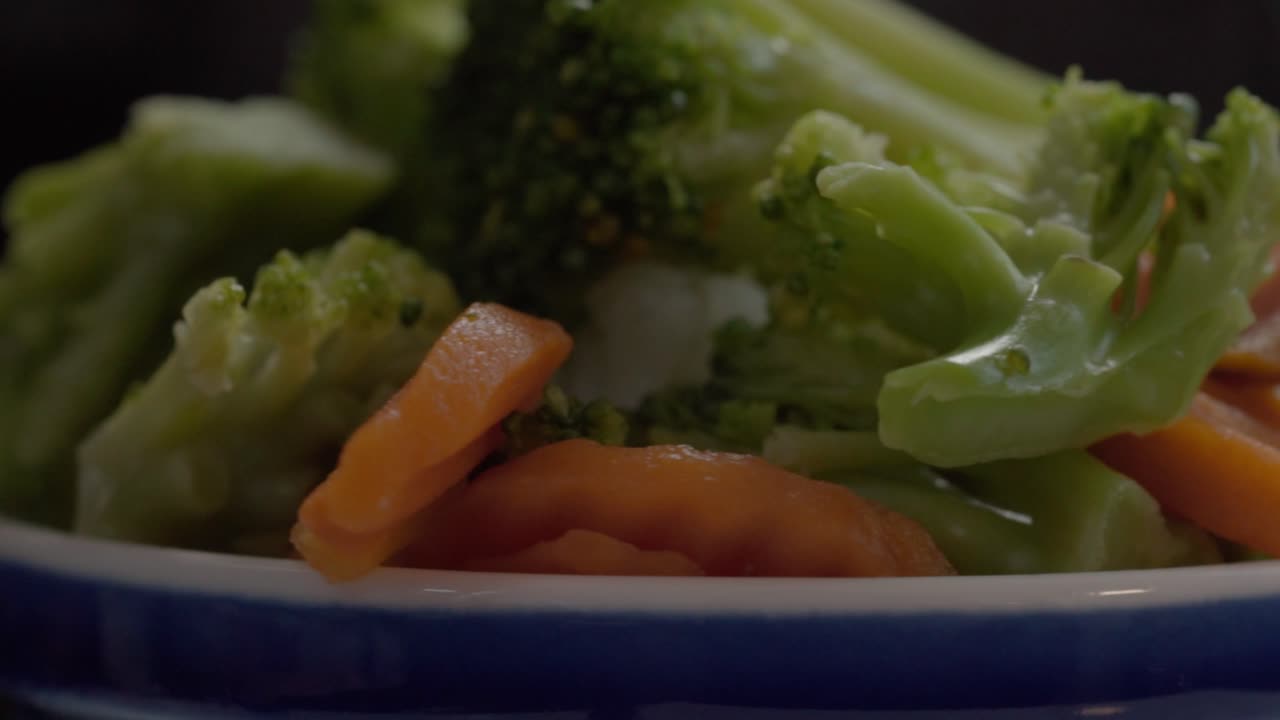 Healthy cooked broccoli and carrots in a detailed close-up