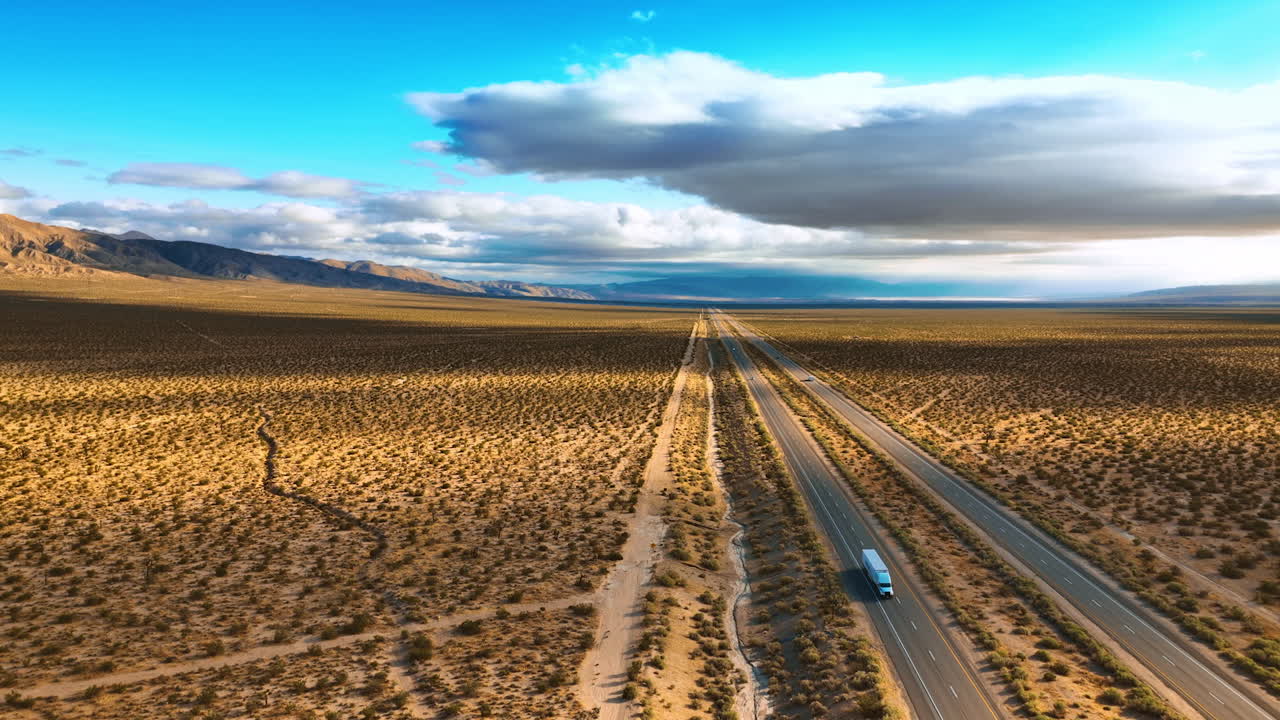 Amazing view of the desert crossed by the highways. Some cars move by the roads. Aerial perspective.