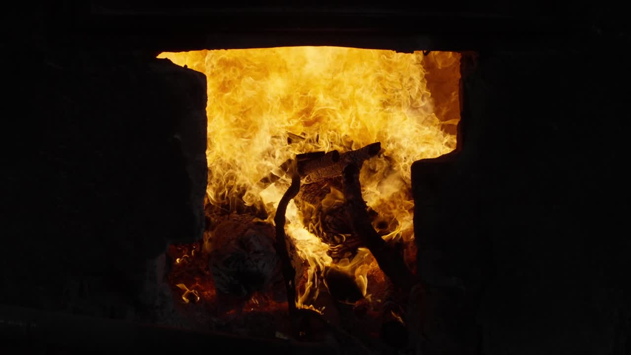 ZOOM OUT SLOW MOTION SHOT OF A WOOD FURNACE