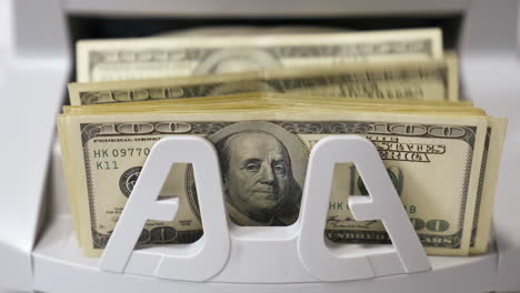 counting process of dollar banknotes. automated financial operations. currency counting machine counts hundred dollar bills. banking and commercial activity. close-up.