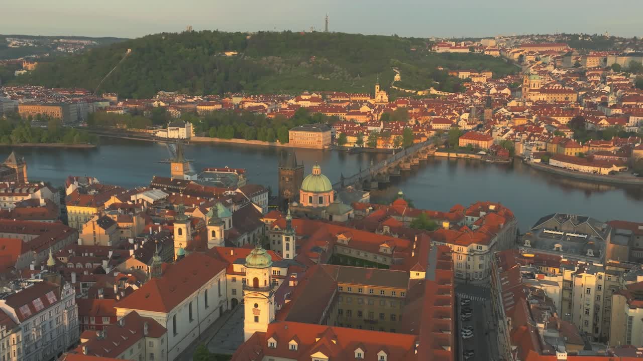 Aerial pan shot of Prague city centre, Charles Bridge and Elbe during summer afternoon in Czech Republic
