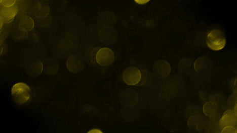 Bokeh-shining-colorful-particles.-Shimmering-Glittering-Particles-loop-animation-with-black-background