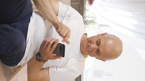 Vertical-video-of-The-forgetful-old-man-is-solving-puzzles.