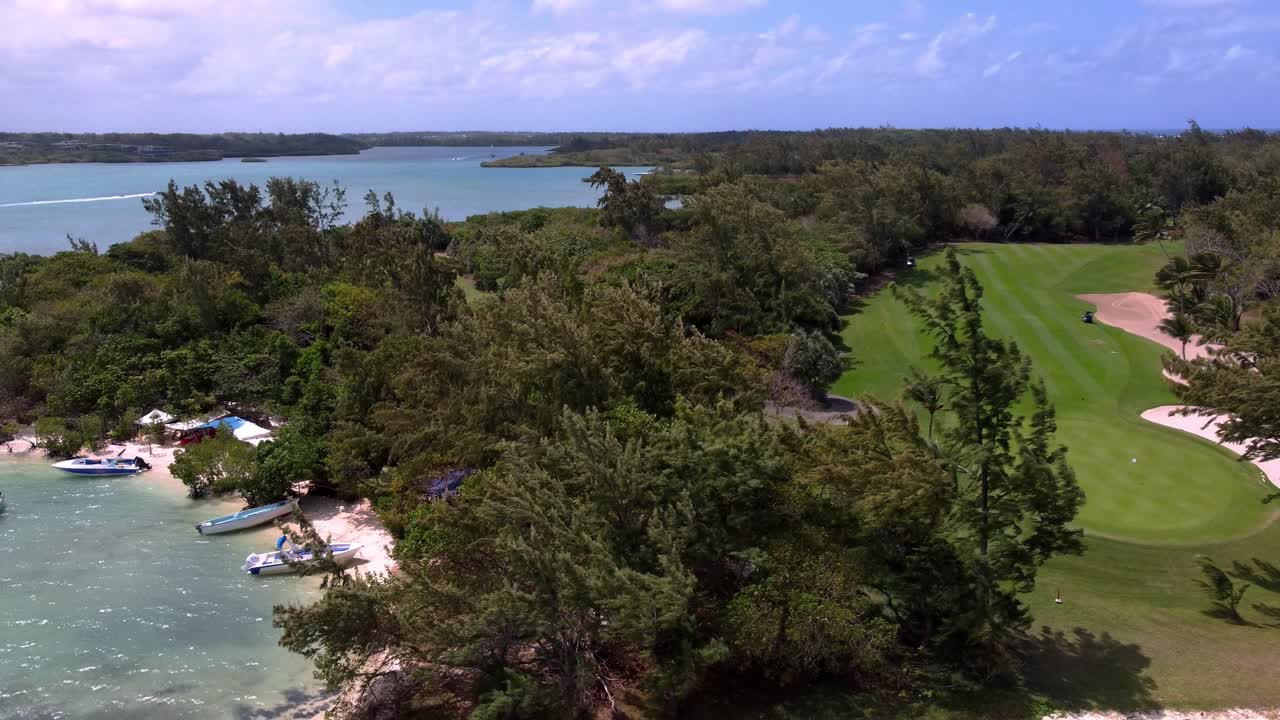 Spectacular aerial view of Île aux Cerfs, Mauritius, highlighting the beach and golf course surrounded by turquoise waters.