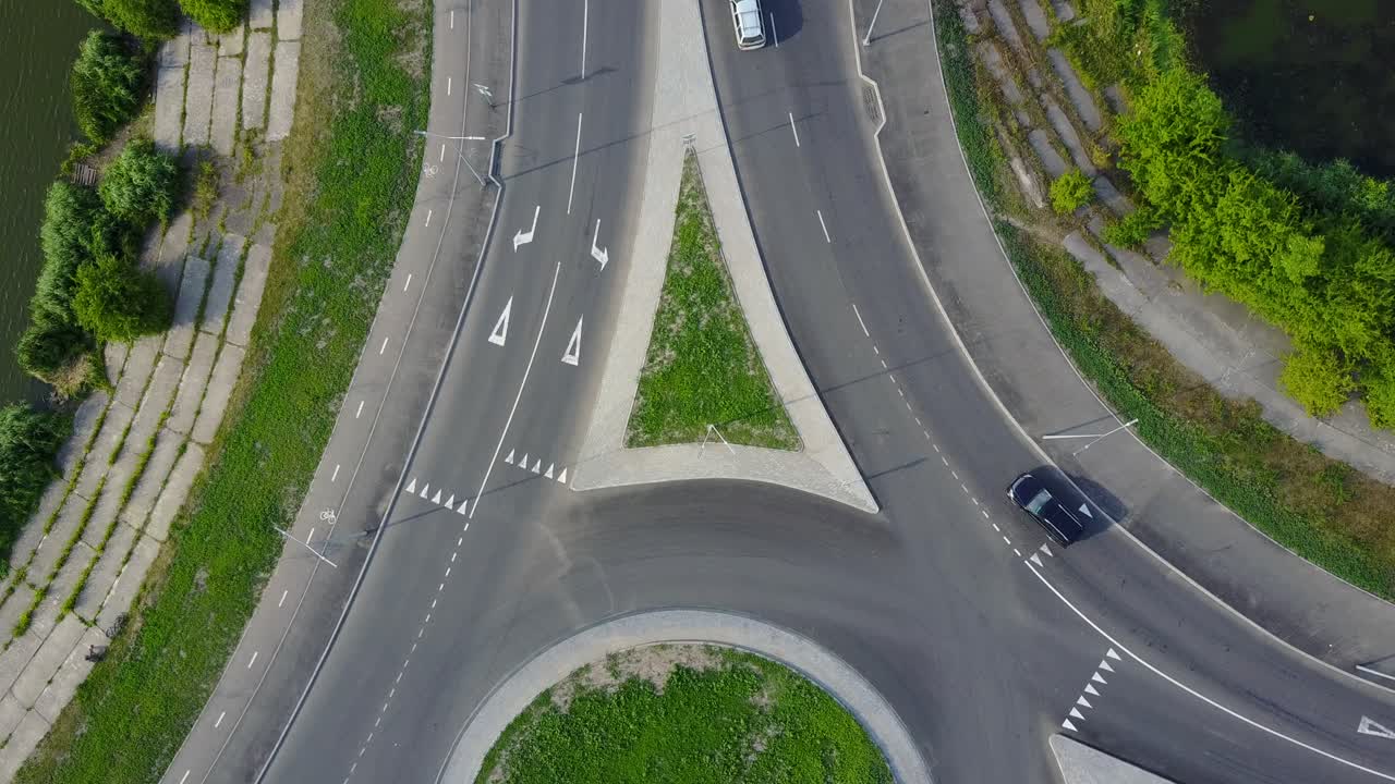 City Traffic At Roundabout. Flying above huge roundabout full of cars and trucks at rush hour