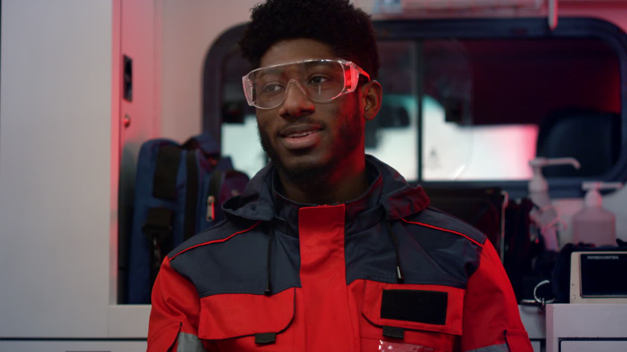 Emergency care assistant talking with colleague in ambulance car