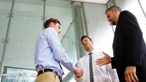 businessmen shaking hands in office
