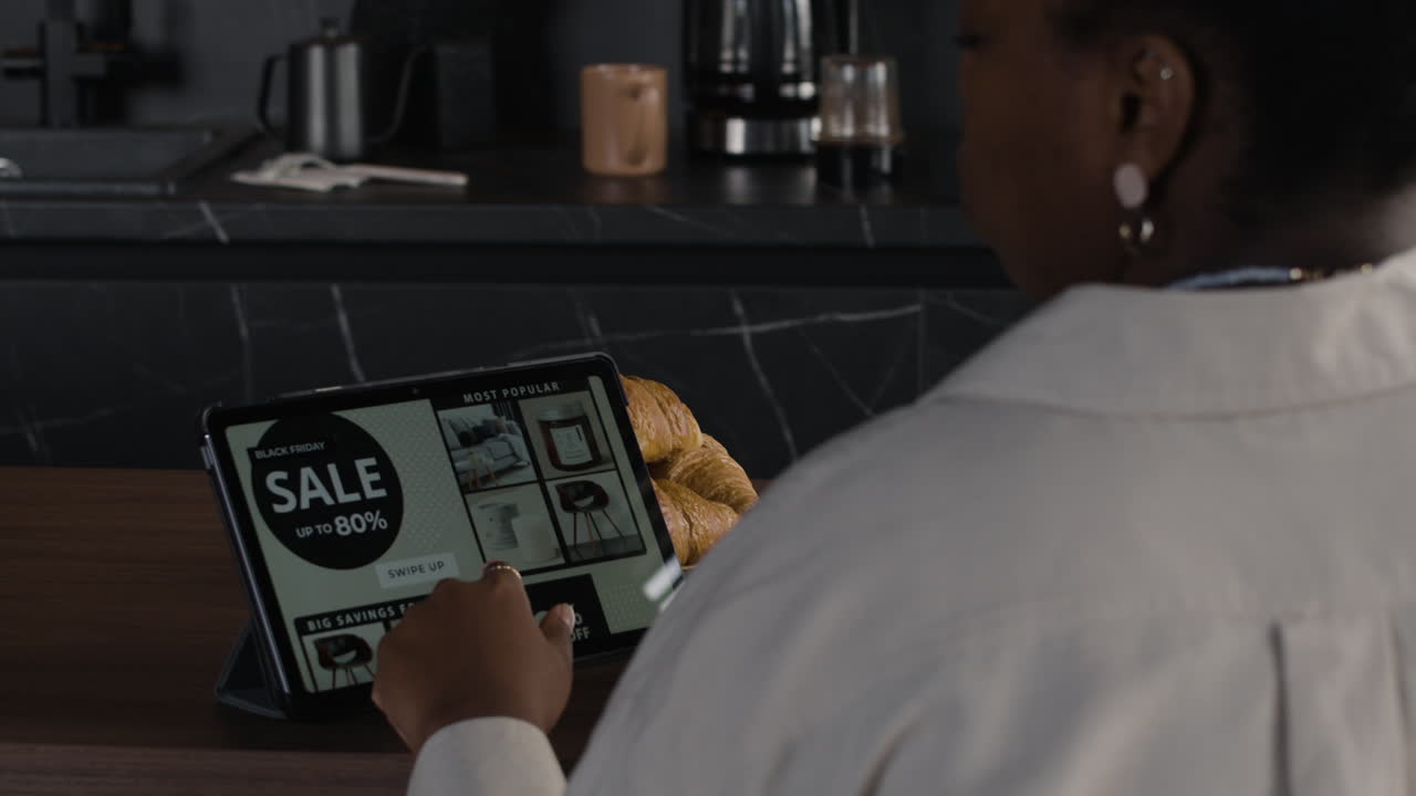 Woman using a tablet in the kitchen