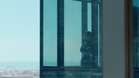 confident business woman using smartphone ceo talking to client negotiating corporate deal female consultant for sales company having phone call working in office looking out window at city