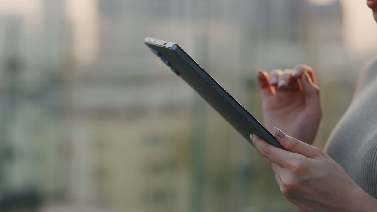 Close-Up of Woman's Hands Using a Digital Tablet Outdoors