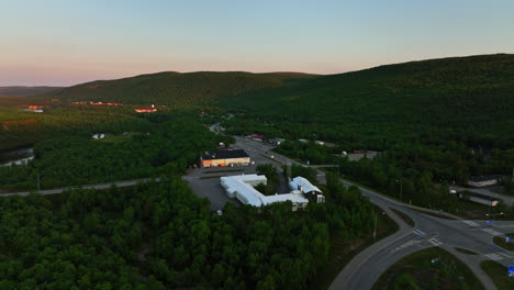 Aerial-view-around-the-downtown-Utsjoki-village,-midnight-sun-in-Lapland,-Finland